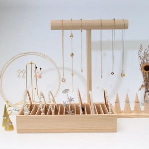 Detailed arrangement of wooden jewelry display stands for necklaces, rings and hairbands