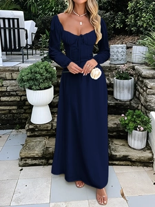 Elegant navy blue square neck maxi dress with puff sleeves in a garden setting