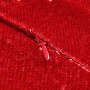 Detail of red sequins fabric and matching invisible zipper on back of evening gown