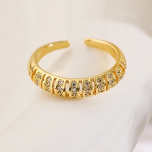 Macro detail of gold-plated Love ring with micro-paved cubic zirconia stones