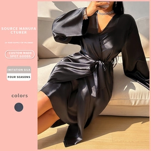 Detail view of smooth imitation silk fabric and waistband tie on this elegant black robe