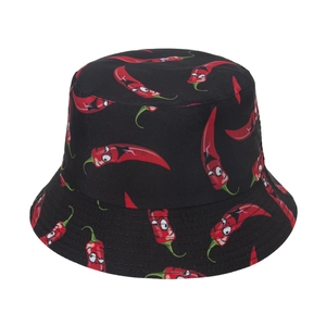 Close-up of the cartoon red chili pepper pattern on a black cotton bucket hat fabric