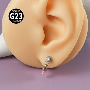 Détail d'une boucle d'oreille cône rose en titane G23 sur un modèle d'oreille