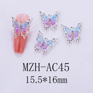 Macro detail of laser gradient butterfly nail charm with silver hollow metal edges