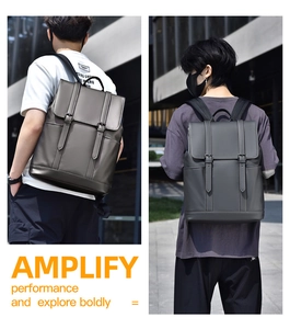 Detail of grey synthetic leather backpack with flap buckles and wide shoulder straps