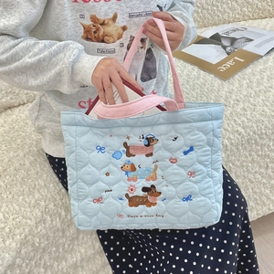 Close-up of quilted tote bag with cute cartoon dog embroidery and Have a nice day text