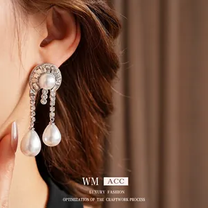 Baroque style silver earrings with drop pearls and sparkling rhinestone details