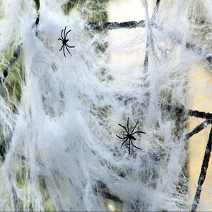 Close-up of stretchy white spider web and two black spiders for Halloween decor
