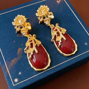 Vintage gold flower earrings with teardrop red gemstones and diamond accents