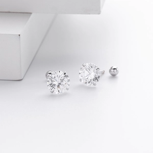 Detailed view of sterling silver screw back earrings with 4-prong set cubic zirconia