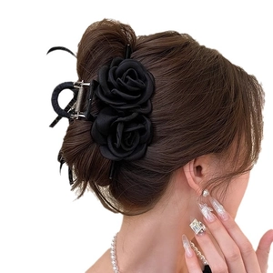 Elegant large black silk rose hair claw clip for women shown on a model from a side view