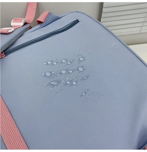 Close-up of light blue waterproof fabric with water droplets on a stylish backpack