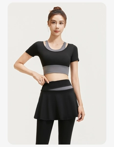 Detail of high-elasticity yoga set with layered skirt leggings and breathable black top