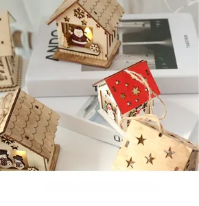 Close-up of wooden glowing Christmas house ornaments with LED lights and star cutouts
