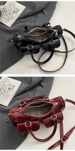 Detail of Boston-style saddle bag showing glossy leather texture and front magnetic pockets
