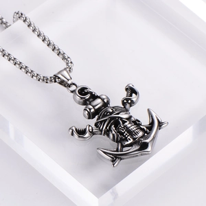 Detailed macro view of retro pirate skull pendant with anchor and cross swords design