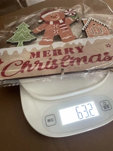 Christmas wooden hanging signs with gingerbread man and Merry Christmas text on a scale