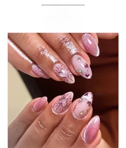 Macro detail of almond-shaped pink cat-eye nails with heart pattern and small rhinestones