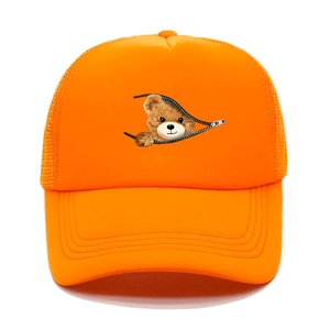 Close-up of breathable mesh and cartoon bear print on orange trucker baseball cap