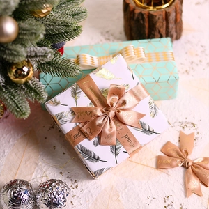 White gift box with gold feathers and Eternal Love rose gold ribbon for holidays