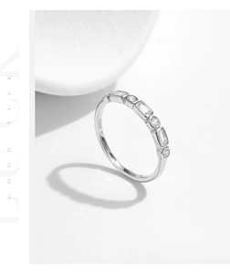 Detail of S925 sterling silver band featuring polished finish and square cut zircons