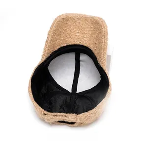 Detail view of khaki lamb wool baseball cap interior with black lining and warm fabric