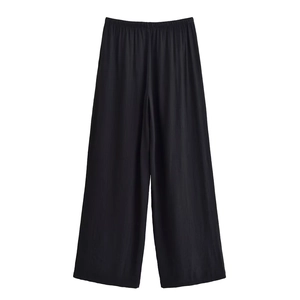 Detail of black wide-leg pants featuring an elastic waist and premium draped crepe texture