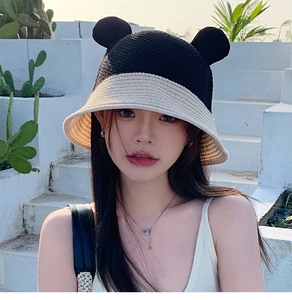 Close-up of contrast knit bucket hat featuring cute bear ears and woven texture detail