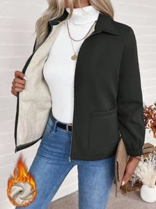 Women's black zip-up jacket with white fleece lining and side pockets in a stylish cut