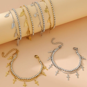 Double-layered stainless steel bracelet with star, cross and leaf charms in gold and silver