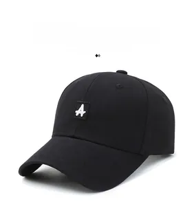 Close-up of black baseball cap featuring white letter A embroidery and cotton twill texture