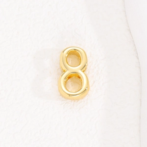 Macro view of gold number eight bead for 10mm stainless steel mesh bracelet