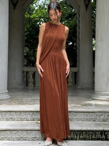 Slim-fit brown sleeveless ruched maxi dress featuring an elegant halter neck and draping