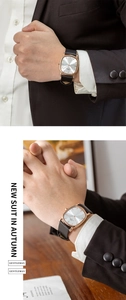 Detailed view of men's ultra-thin oval watch with rose gold case and black leather strap