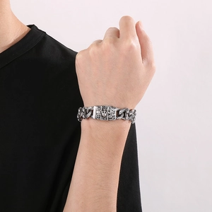 Detailed close-up of a men's punk skull bracelet buckle with ornate metal engravings