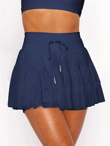 Detailed view of dark blue layered mesh tennis skirt with drawstring elastic waist