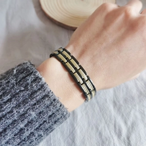 Men's fashion magnetic wheat link bracelet in black and gold stainless steel on wrist