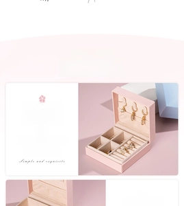 Macro detail of the pink leather jewelry box featuring ring slots and a storage grid