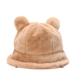 Detailed close-up of fluffy light brown teddy bear ears on a plush winter bucket hat