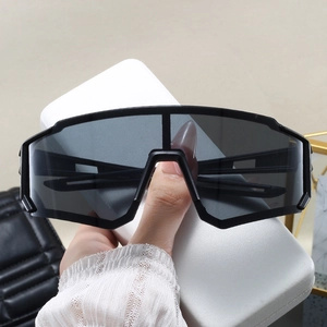 Macro shot of sporty oversized black frame sunglasses featuring dark grey shield lens