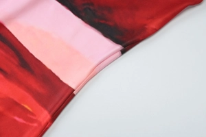 Macro shot of high-quality red floral fabric texture and seamless side stitching detail