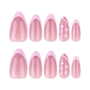 Short almond press-on nails with pink gradient French tips and white floral designs