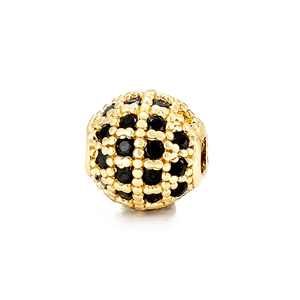 Macro shot of 8mm gold spherical bead with micro-pave black zircon stones for DIY jewelry