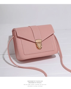 Detailed shot of pink PU leather crossbody bag featuring white stitching and gold buckle