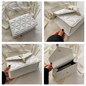 Detail view of white quilted PU leather handbag with gold metal lock and spacious interior