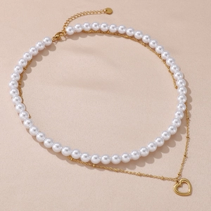 Double-layered gold chain and pearl necklace featuring a hollow heart-shaped pendant