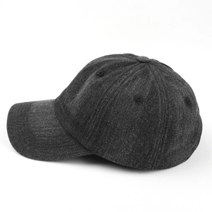 Close-up of a dark grey denim baseball cap showing six-panel stitch and curved brim