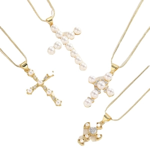 Elegant gold cross necklaces with pearls and zircons on a clean white background