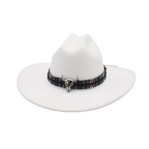 Close-up of white wool fedora hat with ethnic woven band and silver bull skull ornament