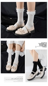 Detailed shot of double-layered lace cuffs on Mary Jane socks with cute bow accents